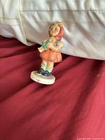 Front view of Goebel Hummel girl figurine on base