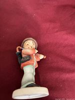 Full view of the figurine showing front details and colours