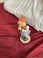 Front view of Hummel girl figurine on round base