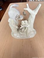Front view showing child figure, knit hat, tree, star, birds in nest