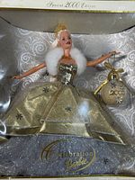 Front view of boxed Celebration Barbie showing gown and ornament
