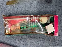 Front view of Barbie Holiday Joy doll inside box