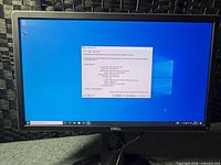 Dell monitor displaying Windows desktop and DxDiag window