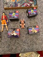 Overview with Luffy figure, four Nanoblock boxes, toy car