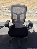 Front view of black mesh high-back office chair with armrests and casters