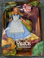 Front of boxed set showing Alice doll, Cheshire Cat, Wonderland artwork