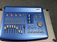 Top view of Tascam US-428 on flight case showing faders, knobs, transport controls