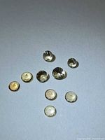 All nine faceted Tanzanite gemstones grouped, showing color and cut