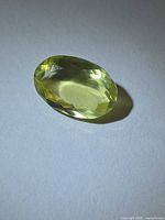 Top view of oval faceted yellow citrine gemstone