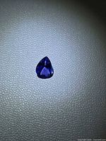 Pear-cut Tanzanite on textured surface