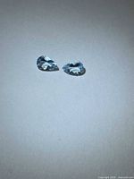 Front view of two pear-cut aquamarines on neutral background