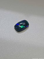 Front view of the opal showcasing blue-green play-of-color