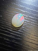 Top view of oval opal showing play-of-colour
