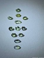 All 14 faceted Tanzanite stones arranged in vertical line