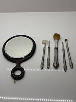 Full vanity set showing mirror and five brushes