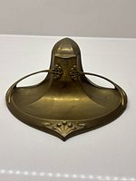 Front view of brass Art Nouveau inkwell