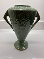 Front view showing overall form, twin handles, and swirl decoration