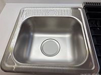 Top view showing interior bowl, drain opening and faucet knockout