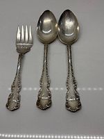 Front view of three Birks sterling pieces showing fork and two spoons