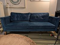 Front view of blue velvet couch