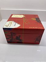 Closed red presentation box with wax seal motif