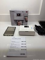 Printer, box, manual, cassette and adapter overview