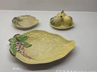 Three Carlton Ware yellow leaf dishes and cruet set