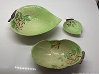 Three Carlton Ware Apple Blossom dishes grouped: large platter, oval dish, small dish
