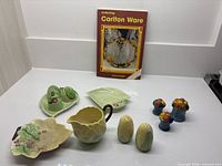 Group shot showing all pottery pieces and reference book