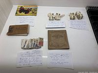 Overall view of three cigarette card sets, two vintage books and a cigarette card album
