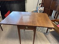 Table fully open showing both leaves and drawer