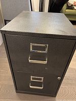 Front view showing two drawers, handles, label holders, lock
