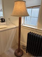 Full view of mahogany faux-bamboo floor lamp with shade