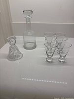 Full lot shot showing decanter with stopper, candle holder and six liqueur glasses
