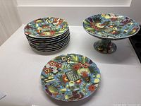 stack of eight plates and pedestal compote showing complete lot