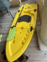 Top view of yellow Origami Paddler with seat pad and paddle clipped on