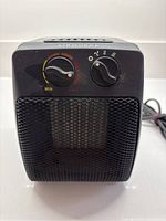 Front view showing control dials, grille, brand marking