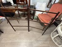 Tri-panel hinged wooden quilt rack standing open on floor