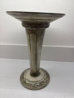 Full side view of ceramic stemmed vase showing overall form and decorative details