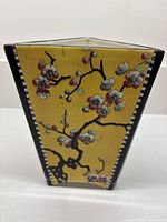 Front view of yellow floral triangular vase