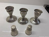 Full view of three candle holders and two shakers