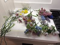 Group of assorted beaded flower stems spread on countertop