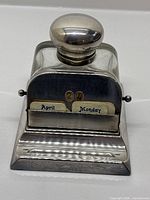 Front view showing silver-plate inkwell with date cards reading 24 April Monday