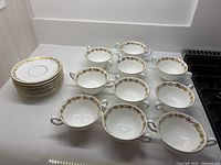 Stack of saucers and grouped bowls showing total quantity and pattern