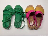 Both pairs of sandals side by side showing style and colors