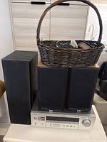 Receiver, three speakers and basket of cables overview