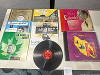 Sleeved records and one bare Columbia disc on tabletop