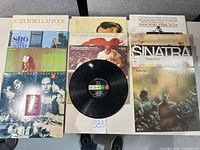 Overhead view of two stacks of LP jackets plus loose Decca disc