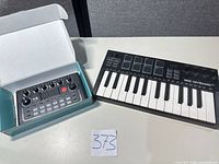 Top-down view of MIDI keyboard and sound card with box