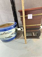 Blue & white ceramic planter beside wood planter on stand